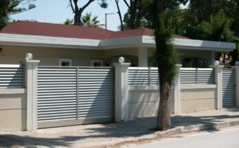 a house with a white fence and a red roof